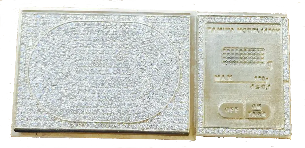 Custom diamond pavé setting on gold scale showing precision work